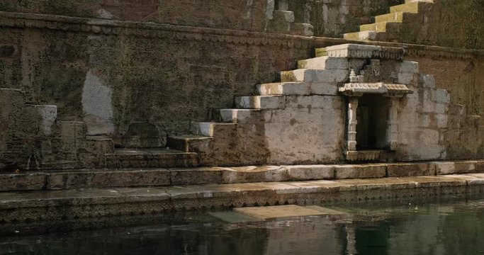 Toorji Ka Jhalra Baoli stepwell and water storage inside it - one of water sources in Jodhpur, Rajasthan, India. Horizontal pan