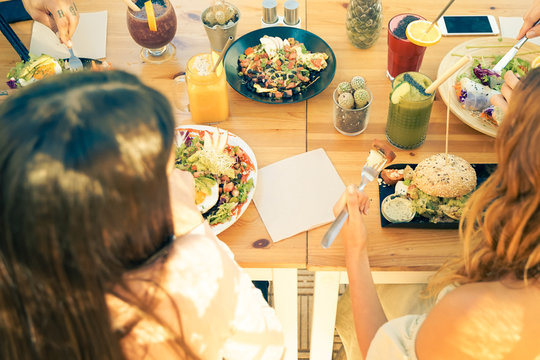 Top view of the vegetarian food, colored smoothie bowl in the bar outdoor. Erasmus students chatting and eating in the vegan and vegetarian restaurant - Food, drink and friendly concept - Image