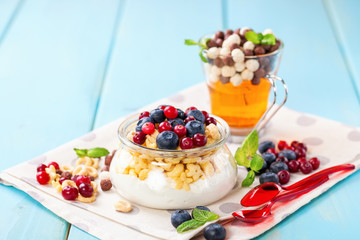 Yogurt with cereal and berries. Selective focus. Copy space