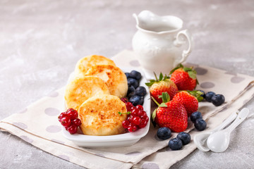 Cottage cheese pancakes with berries. Selective focus. Russian cheesecakes. Copy space