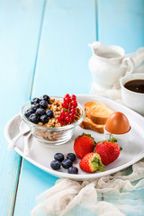 Breakfast - muesli, berries and coffee. Selective focus. Copy space