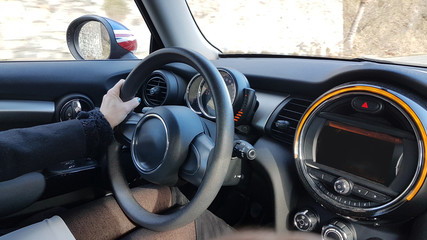 steering wheel drivers hands and modern black car