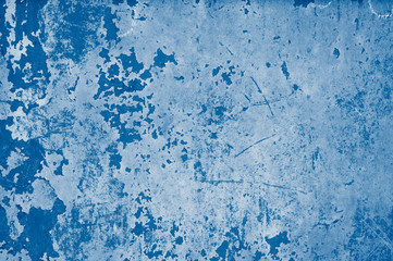 Plastered wall with peeling paint in red, biue  and pink colors  in classic blue trendy color of the year 2020