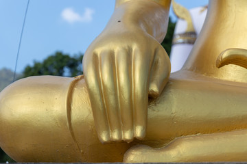 Statue of Buddha's hand on its legs.
