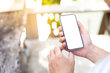 Mockup image blank white screen cell phone.man hand holding texting using mobile.background empty space for advertise text.people contact marketing business,technology 