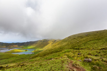 Sun dots the rim of the Corvo volcanic crater on the island of Corvo in the Azores, Portugal.