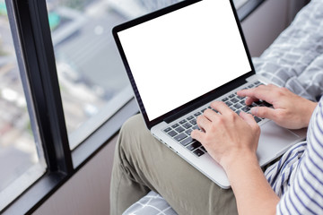 mockup image blank screen computer with white background for advertising text,hand man using laptop contact business search information at home office.marketing and creative design