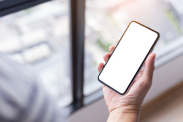 Mockup image blank white screen cell phone.woman hand holding texting using mobile background empty space for advertise text.people contact marketing business,technology 