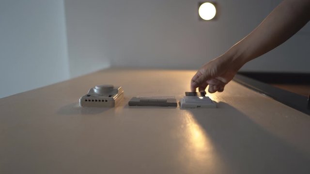 Down view hand holding key card insert box card for open and close system in room