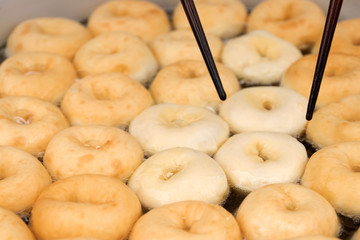 Deep frying doughnuts in hot oil. Made of fresh ingredients tasty.