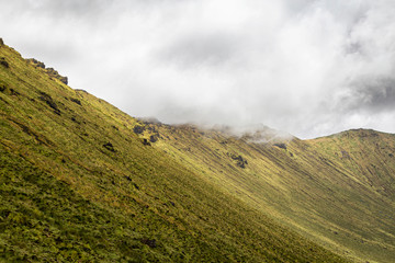 Quick moving clouds moving across the rim of the Corvo Crater on the island of Corvo in the Azores, Portugal.