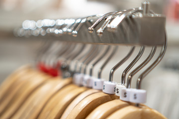 Close up clothes hangers on rack. Background for fashion retail shop shop and apparel store.