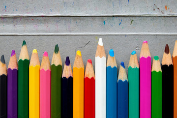 Rows of used color pencils showing blunt nips with color markings on the box casing. Concept for...