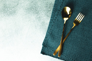 Fork and spoon on table background with space
