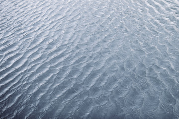 Water waves surface background. Aqua background texture. Abstract water ripples selective focus. Design element for banner and artwork