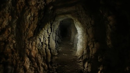 Flashlight or Torch on Walls of Abandoned Mine Tunnel