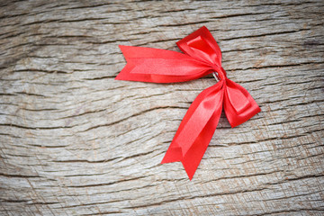 Red ribbon bow on wooden background - gift bow hairpin perfect holiday handmade
