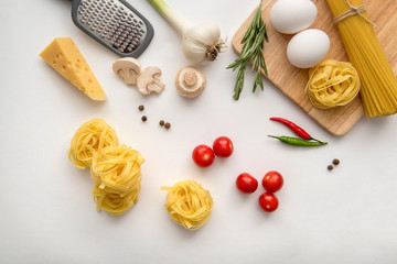 Obraz na płótnie Canvas Ingredients for pasta cooking on white background