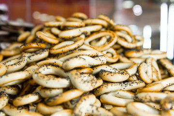 Bagels with poppy seeds. Confectionery poured into a large pile.