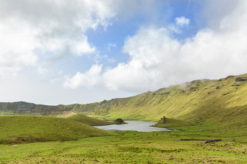 Light summer blue sky peaks into the basin of the Corvo Crater on the island of Corvo in the Azores, Portugal.