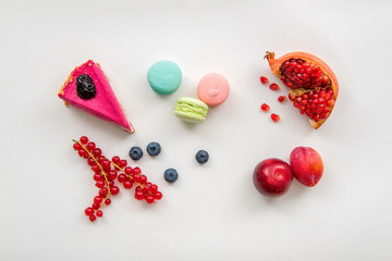 Sweets, fruits and berries on white background for coffee