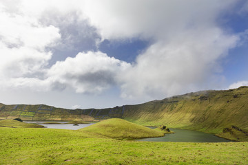 Fototapeta na wymiar Wafting white clouds over the lakes in the Corvo caldera on the island of Corvo in the Azores, Portugal.