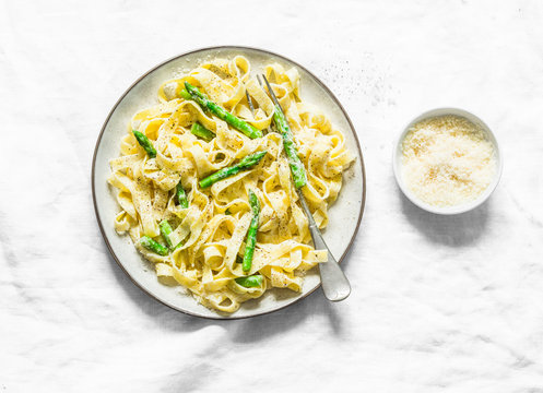 Creamy Sauce Fettuccine Pasta With Asparagus On A Light Background, Top View