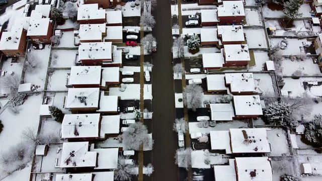 Aerial shot of snowy sub division homes street