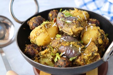 Food - Traditional Indian Gujarati dish Surti Undhiyu. Its a mixed vegetable dish cooked with stuffed brinjals, fried potatoes, Methi Muthia, purple yam, Papadi and spices. Makar Sankranti Special.