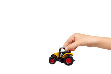 Yellow plastic traktor toy. Farming vehicle, harvest equipment.