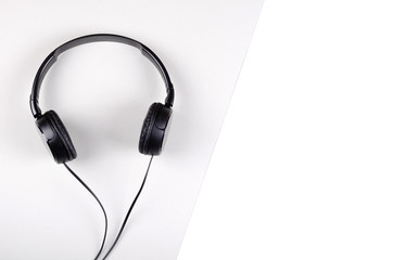 Black headphones composition on gray background. Flat lay.