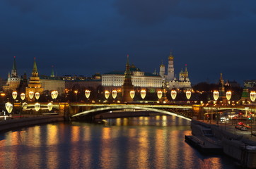 Beautiful evening view of the Moscow Kremlin and the Big Stone bridge with festive illumination. Moscow, Russia
