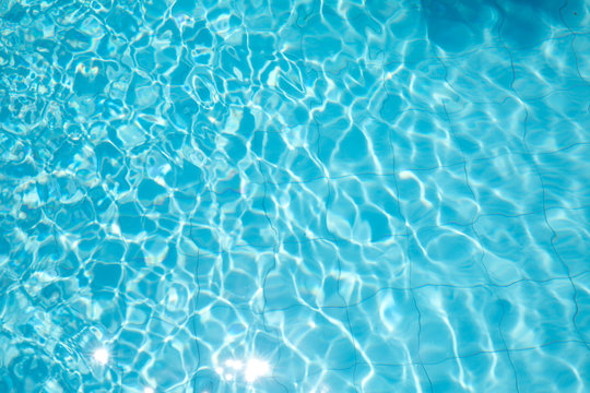 ripped water in swimming pool .surface of blue swimming pool,background of water in swimming pool.
