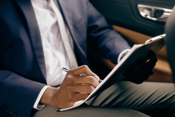 Close up of a businessman signing paperwork.