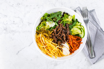 Healthy lunch bowl on marble table background. Delicious balanced food concept. Top view, flat lay, copy space