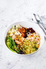 Healthy lunch bowl. Salad with meat, cheese, bulgur and vegetables on marble background. Copy space