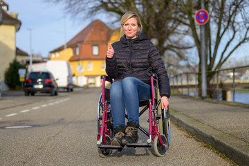 Smiling handicapped woman using a wheelchair