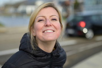 Cute young blond woman with an impish grin