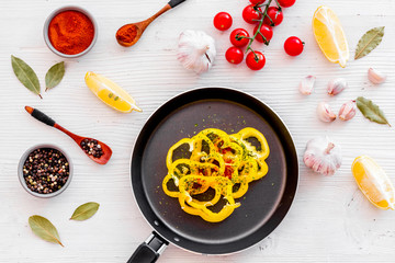 Cooking food concept. Pasta on frying pan near spices and vegetables on white background top-down