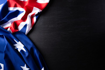 Australia day concept. Australian flag with the text Happy Australia day against a blackboard background. 26 January. - obrazy, fototapety, plakaty