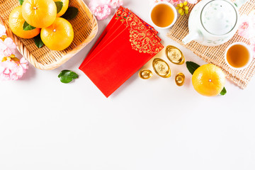Chinese new year festival decorations pow or red packet, orange and gold ingots or golden lump on a...