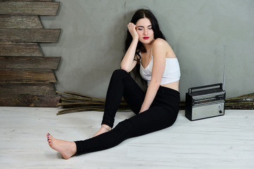 The concept of a glamorous female portrait. Portrait of a pretty brunette girl with long hair with...