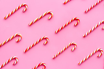 Christmas candy cane pattern on pink background top-down
