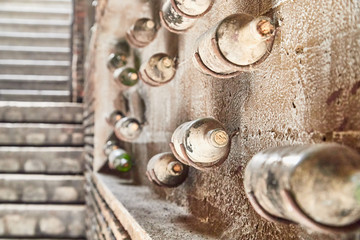 Old, dusty wine bottles in the wine cellar at the winery