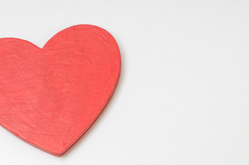 red wooden heart on a white background, wood texture, Valentine with a copy space