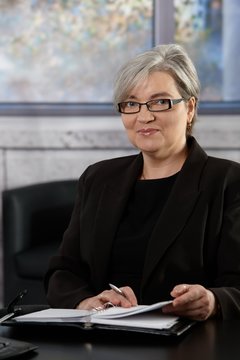 Gray haired mature businesswoman in office
