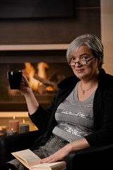 Mature woman at fireplace