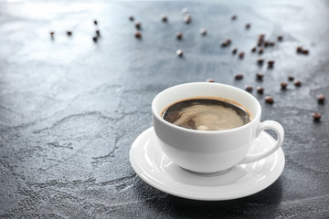 Cup of hot coffee on grey background