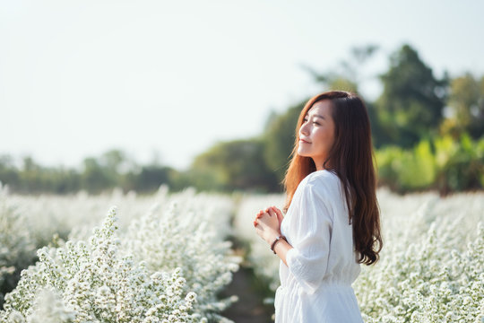 Portrait image of an asian woman in a beautiful Cutter flower field