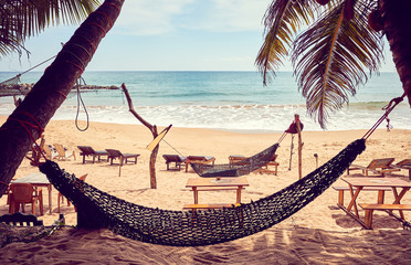 Tropical beach with hammock, color toning applied, Sri Lanka.
